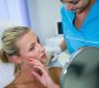woman checking her skin mirror after receiving cosmetic treatment 90x80